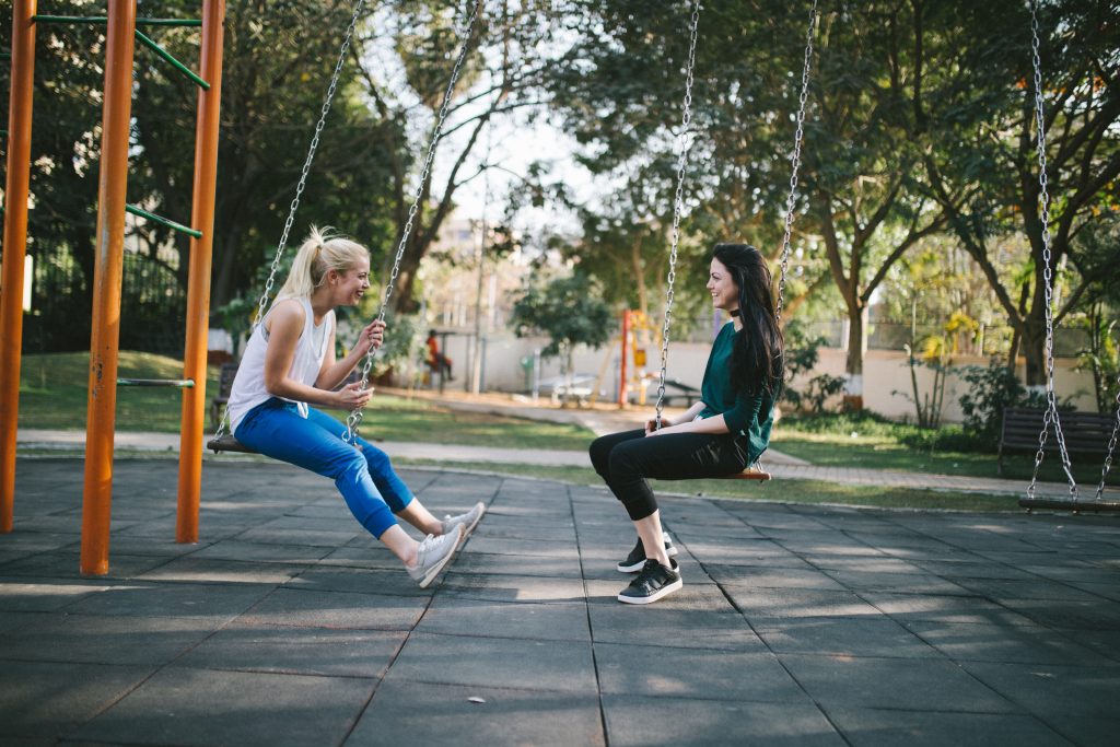 women talking on swing